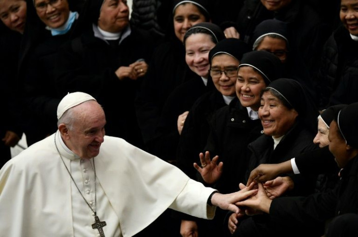 Pope Francis salutes nuns at the end of his general audience at the Vatican's Paul VI Hall on December 1, 2021, ahead of his departure for Cyprus