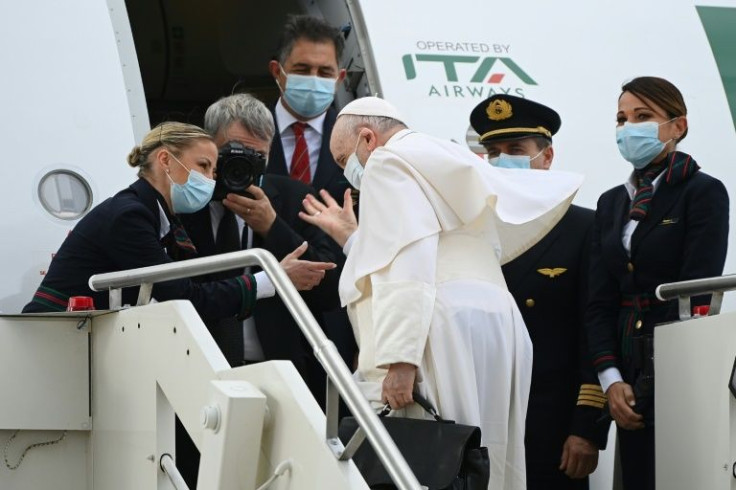 Pope Francis boards a plane at Rome's Fiumicino airport, setting off for a visit to the Mediterranean island nation of Cyprus, before traveling on to Greece