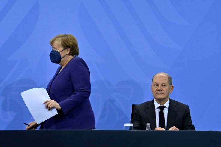 Angela Merkel, seen with designated successor Olaf in the Berlin Chancellery, surprised observers with an eclectic choice of music for her impending ceremonial farewell