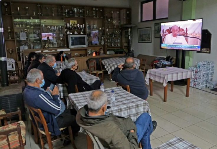 Some watched the event from screens inside the cafe, while others were determined to wait outside
