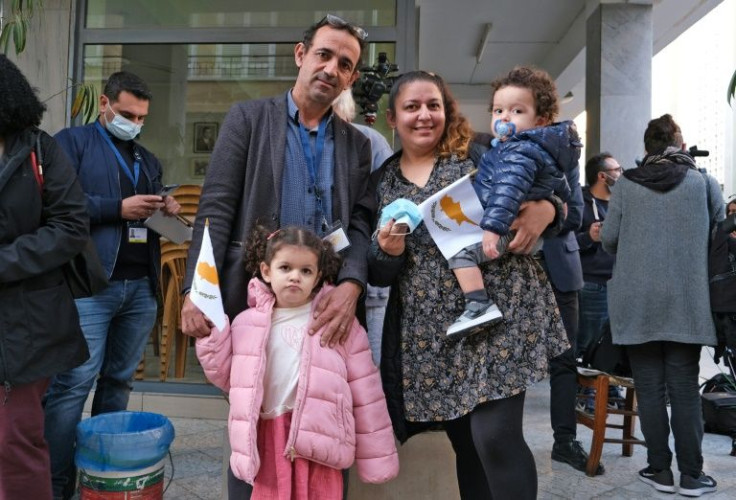 A Cypriot Maronite family waits for Pope Francis to arrive near Nicosia's Maronite Cathedral of Our Lady of Grace
