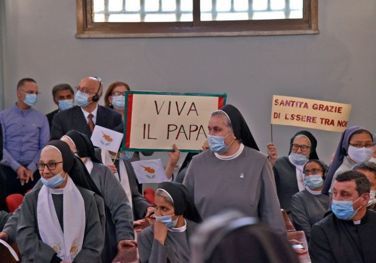 Nuns and other worshippers wait for Pope Francis to enter the Maronite Lady of Grace cathedral in Nicosia for a meeting with priests and members of the Maronite Christian community