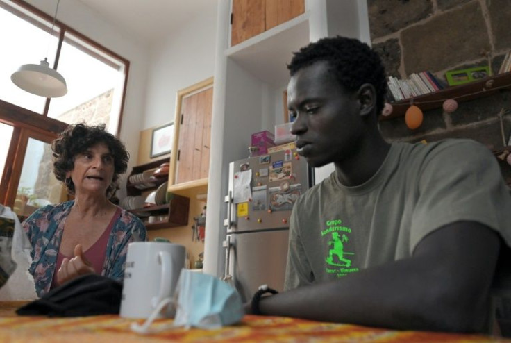 Adelina Abdola decided to offer a roof to homeless migrants and is currently hosting Ousmane, a fisherman from Senegal who is learning Spanish and wants to train as a mechanic, carpenter or welder