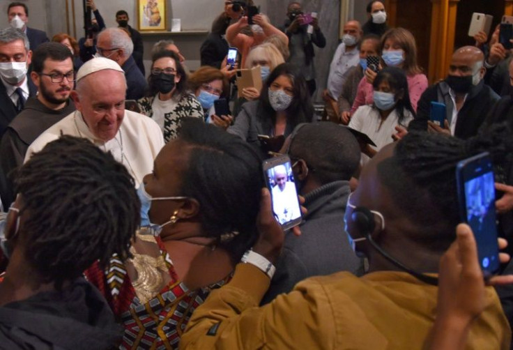 Pope Francis greets migrants at the Roman Catholic church of the Holy Cross near the United Nations buffer zone in the Cypriot city of Nicosia, Europe's last divided capital