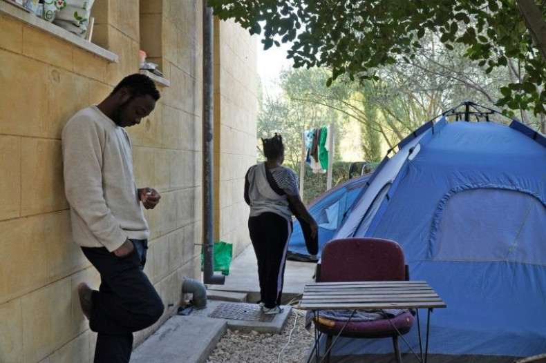 Daniel Ejube (L) and Grace Enjei (R), two Cameroonian nationals, had been stuck in Cyprus's buffer zone since May, living in a tent behind a building