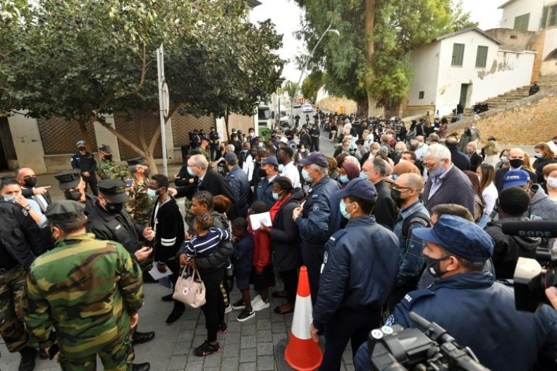 People wait to enter Nicosia's Church of the Holy Cross before an ecumenical prayer with the pope