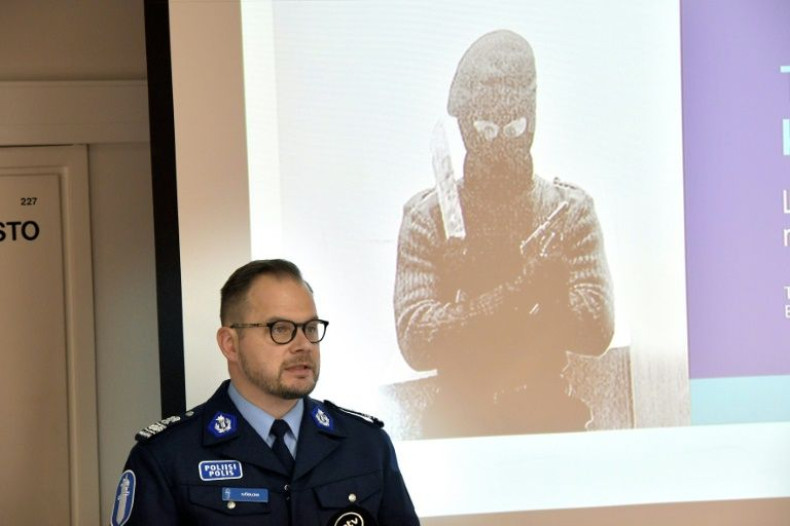 Detective Superintendent Toni Sjoblom, head of investigation, at the Southwestern Finland police department, shows some of the material found during the arrest of five far-right extremists
