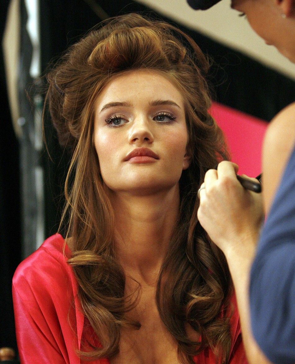 Victorias Secret model Rosie Huntington gets her make-up retouched backstage in preparation of the Victorias Secret fashion show in Hollywood