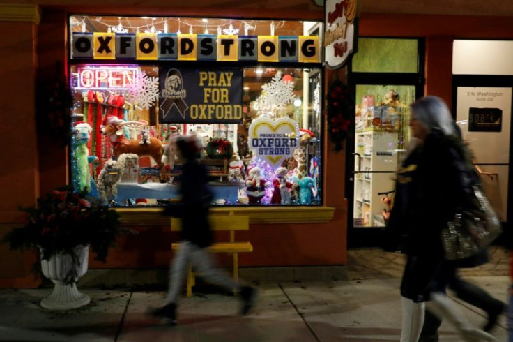 Signs in the window of a store show support for the community after the Oxford High School shooting