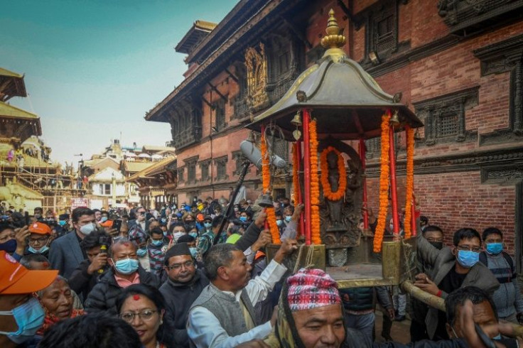 Devotees carry the sculpture in a palanquin, in Patan on the outskirts of Kathmandu