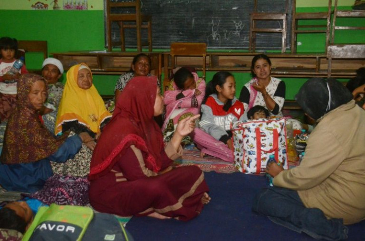 Evacuees take shelter in a classroom in the Indonesian village of Sumberurip on December 4, 2021, after the Semeru volcano erupted