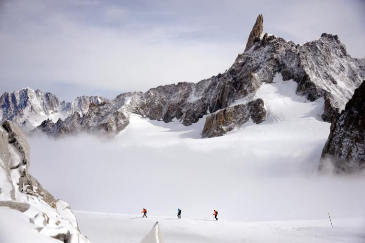 Three climbers walk at an altitude of 3400 metres on September 11, 2013 near the Dent du GÃ©ant (Giant's tooth), in the Mont Blanc massif in France and Italy