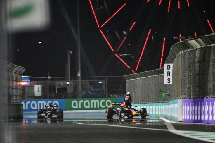 Wall game: Lewis Hamilton drives past the stricken Red Bull of Max Verstappen
