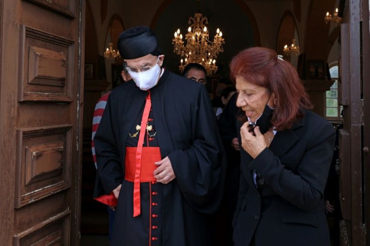 Maria Partella Stefani, pictured with Lebanon's Maronite Patriarch Bechara al-Rahi, is among Maronites allowed back on Sundays to worship at their church in Asomatos village -- but they must return south to the Republic of Cyprus afterwards