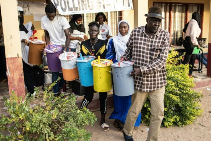 Gambians voted by dropping marbles into coloured tubs, due to high levels of illiteracy