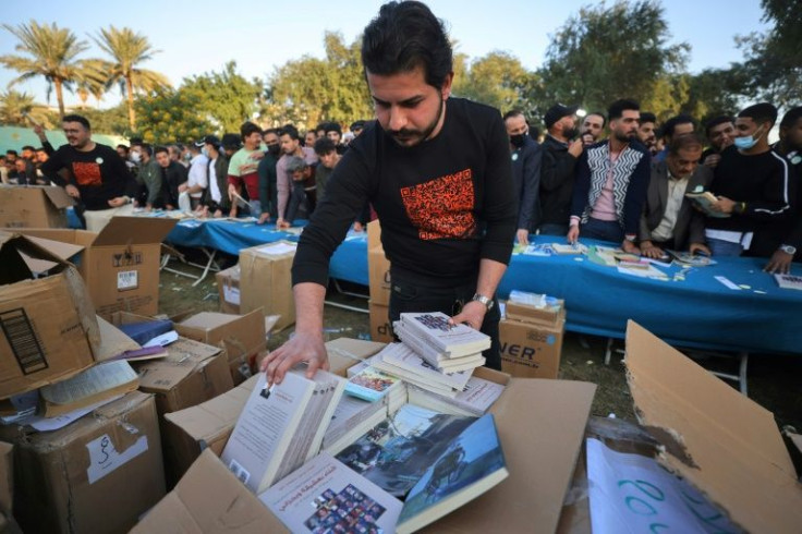 Volunteers at the 'I am an Iraqi, I read' festival in Baghdad listened to requests and distributed books to visitors for free