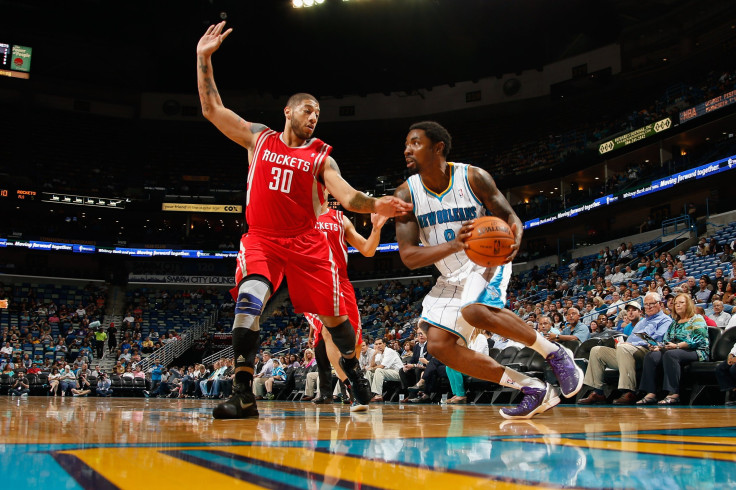 Roger Mason Jr. #8 of the New Orleans Hornets drives the ball around Royce White #30 of the Houston Rockets