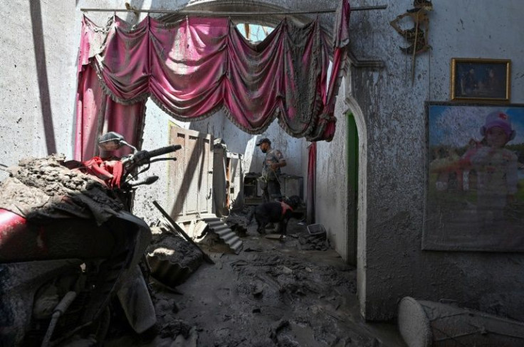 Hot ash ripped through many roofs in the village and homes were filled with grey dust