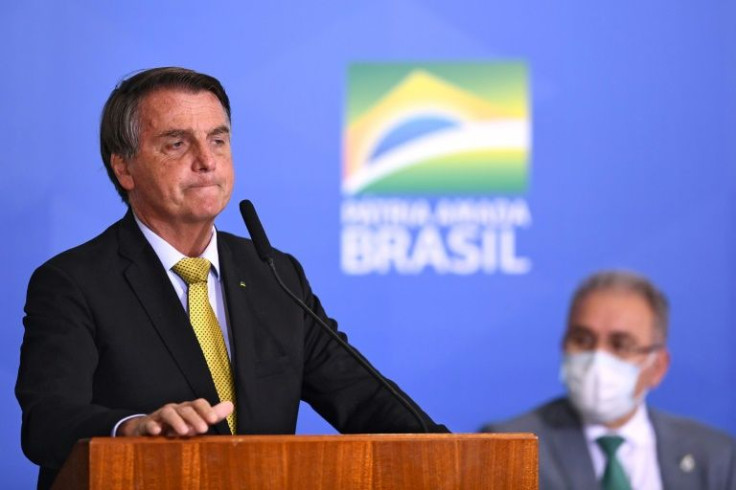 Brazilian President Jair Bolsonaro speaks next to Health Minister Marcelo Queiroga in June 2021
