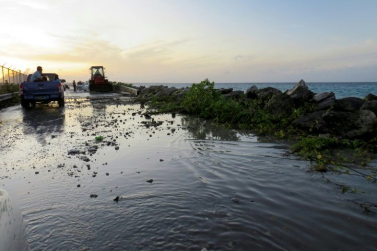 Flooding and debris cover the road to the airport in the Marshall Islands capital Majuro