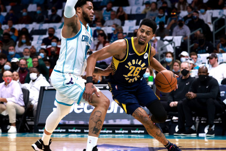 Miles Bridges #0 of the Charlotte Hornets defends Jeremy Lamb #26 of the Indiana Pacers