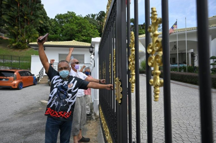 Supporters of former Malaysian prime minister Najib Razak shout slogans outside his residence in Kuala Lumpur
