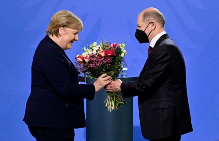 Angela Merkel was present for key moments as new Chancellor Olaf Scholz took over