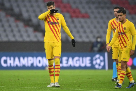 Gerard Pique (L) and Philippe Coutinho at the end of Barcelona's 3-0 defeat at the hands of Bayern Munich that sent them packing from the Champions League