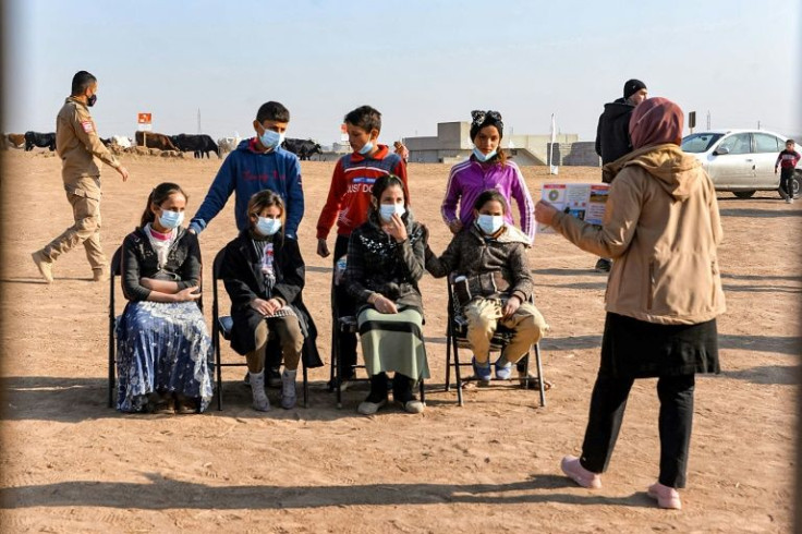 An instructor from global Clearance Solutions (GCS) gives a workshop to children on how to report suspected cases of landmines and unexploded munitions, which have proven deadly for youngsters across Iraq