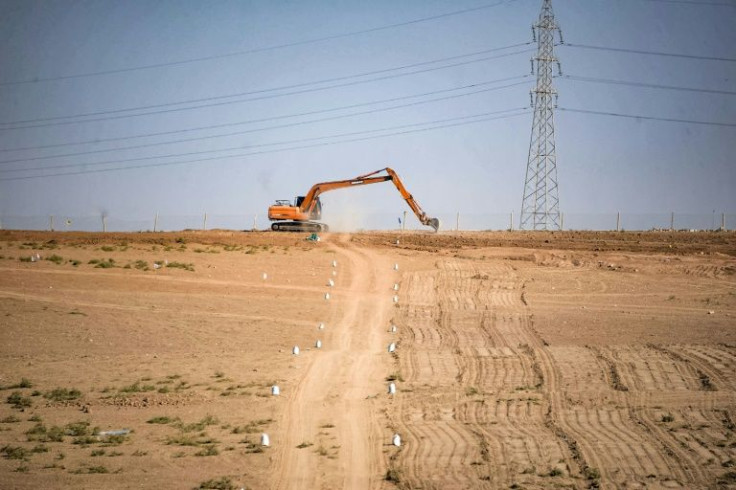 Farmland is contaminated by remnants of war -- here, an excavator ploughs a field as part of the search
