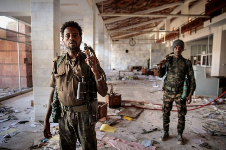 Ransacked: Amhara Fano militia fighters walk in the terminal at Lalibela airport on Tuesday