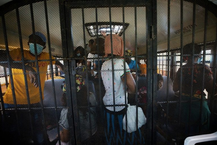 Camy Belizaire, in yellow, is one of the migrants rounded up. He had worked in the Dominican Republic for two years