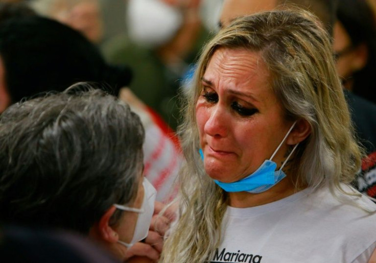 Relatives of victims of the 2013 fire at the Kiss nigthclub react at the end of the trial