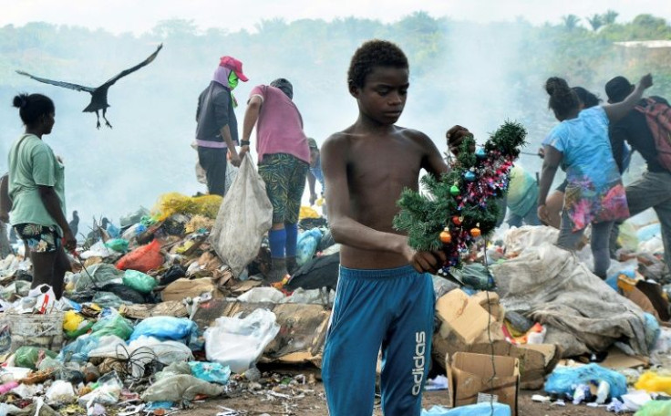 In this file photo Gabriel Silva holds a Christmas decoration he found while scavenging through garbage at the Picarreira landfill of the Cidade das Aguas neighborhood, in Pinheiro, Brazil, on November 08, 2021