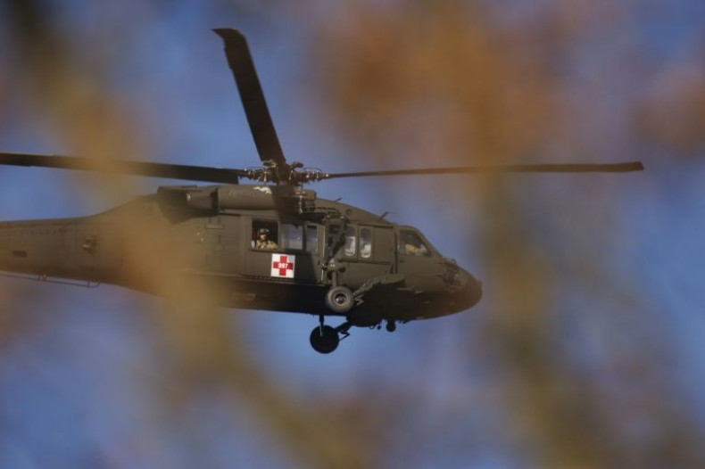 A Kentucky National Guard helicopter surveys the tornado damage near the hard-hit town of Mayfield on December 11, 2021