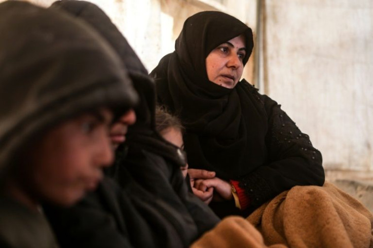 Hanaa al-Yasbu, a displaced Syrian widow, huddles with her children -- she dreams of earning 50 Turkish lira a day 'so they do not sleep hungry'