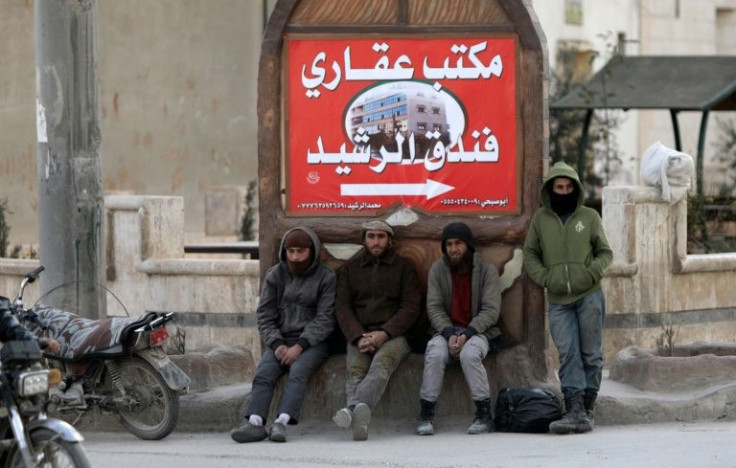 Workers in Al-Bab wait to be picked up for a job -- the Turkish lira's sharp fall has piled more misery on an enclave whose inhabitants are already scarred by war