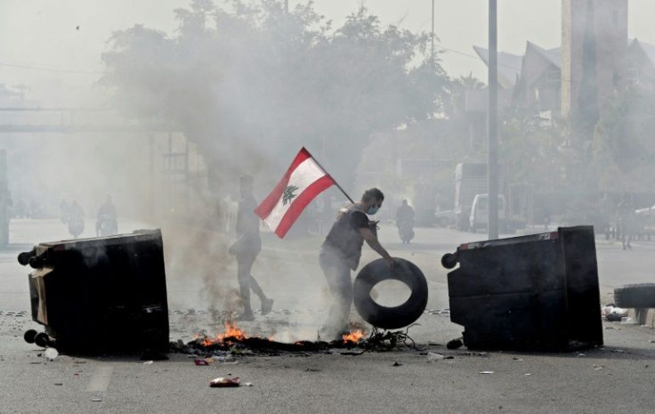 Lebanese protesters block a highway in Beirut on November 29, 2021, as the country struggles with a deep economic crisis -- economic instability in the Middle East is a factor spurring a turn to online banking and financial tools
