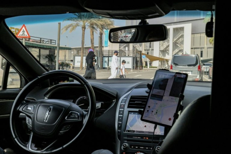 Safety officer oversees a test in real life conditions of a self-driving taxi