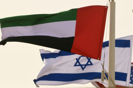 In his file photo taken on August 31, 2020, the Emirati, Israeli and US flags fly at the Abu Dhabi airport at the arrival of the first-ever commercial flight from Israel to the UAE