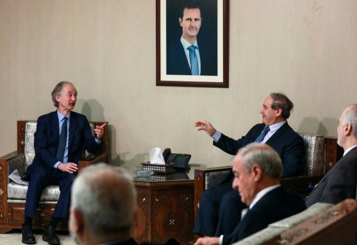 Syrian Foreign Minister Faisal Mekdad (R) receives the United Nations special envoy Geir Pedersen (L) in the capital Damascus