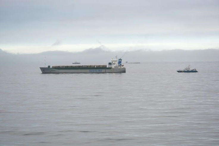 The British cargo ship Scot Carrier (L) and the capsized Danish cargo ship Karin Hoej collided early Monday