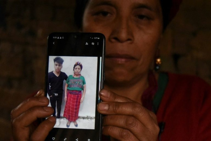 Teresa Mateo with a photo of her dead son Giovani Raymundo, 18