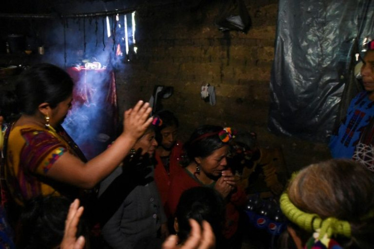 Villagers gather to try and console Raymundo's mother