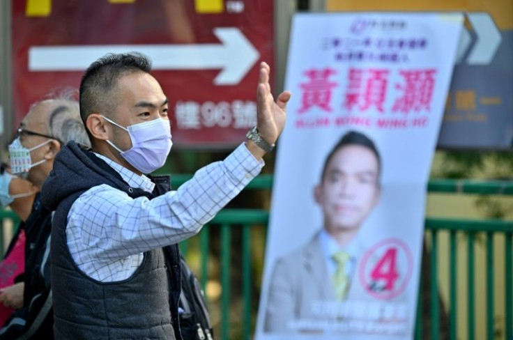 Hong Kong politician Allan Wong greets people as he campaigns ahead of the legislative elections on December 19
