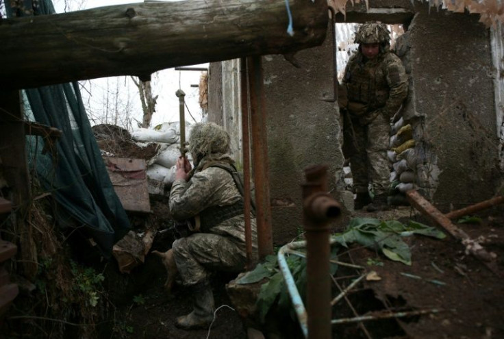 Ukrainian soldiers keep watch on the frontline with Russia-backed separatists near the town of Avdiivka, in the Donetsk region, on December 10, 2021