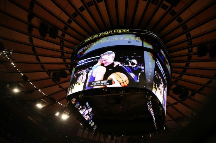 The Madison Square Garden scoreboard shows Stephen Curry celebrating with Golden State Warriors coach Steve Kerr after setting the NBA all-time record for three-point shots