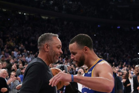 Golden State's Stephen Curry hugs his father Dell Curry after making a three-point basket to break Ray Allenâs NBA all-time record for three-pointers in a game against the New York Knicks