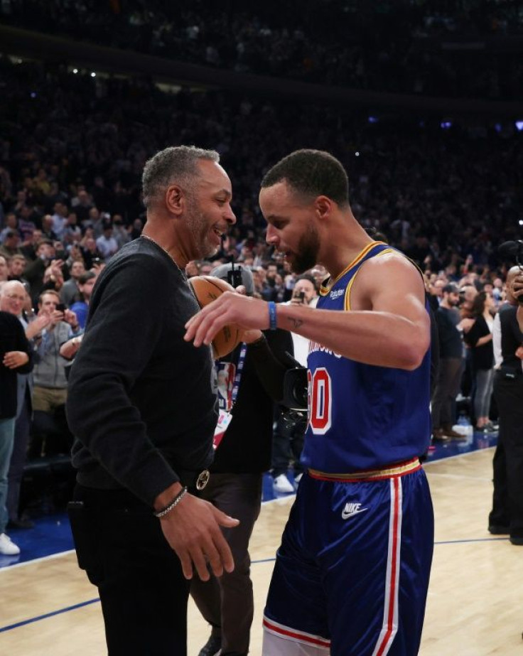 Golden State's Stephen Curry hugs his father Dell Curry after making a three-point basket to break Ray Allenâs NBA all-time record for three-pointers in a game against the New York Knicks