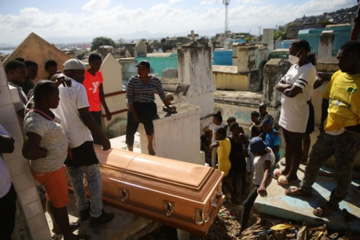 A victim, who died in the December 14 gas tanker explosion in Cap-Haitien, Haiti, is buried on December 15, 2021